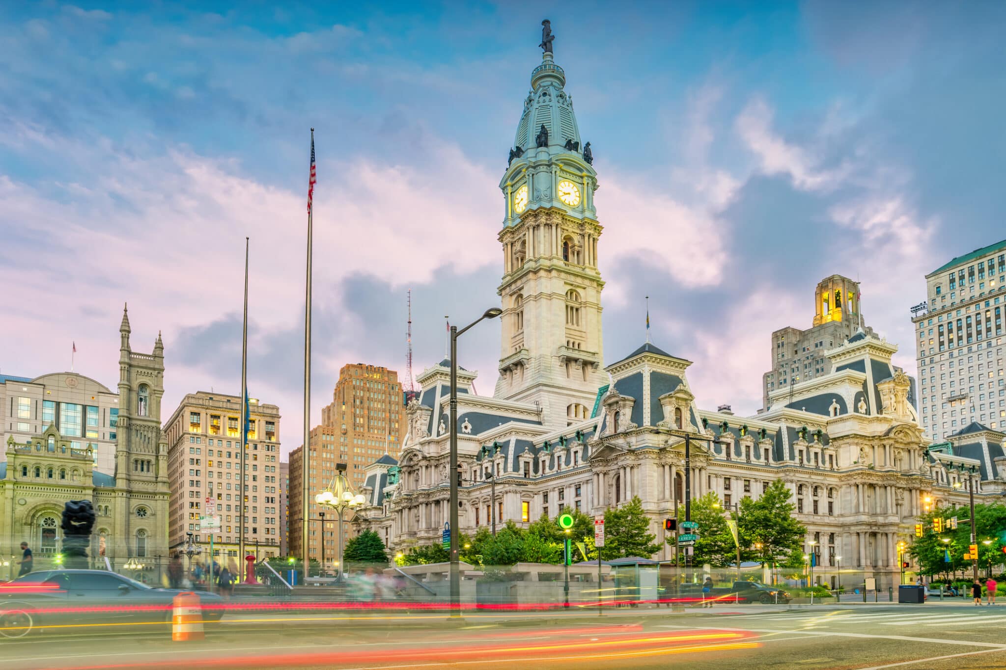 A vibrant city street photo in Philadelphia, highlighted by City Hall.