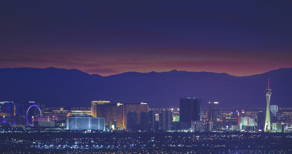 View of the Las Vegas Strip from afar with mountains in background.