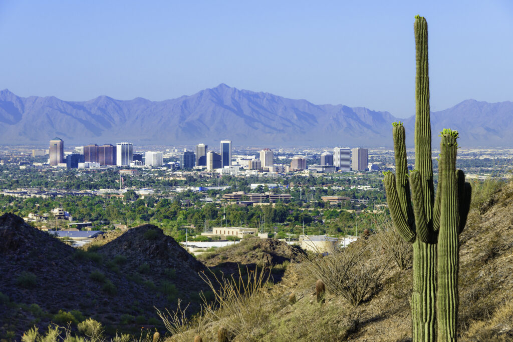 Phoenix skyline framed by saguaro cactus and mountainous desert