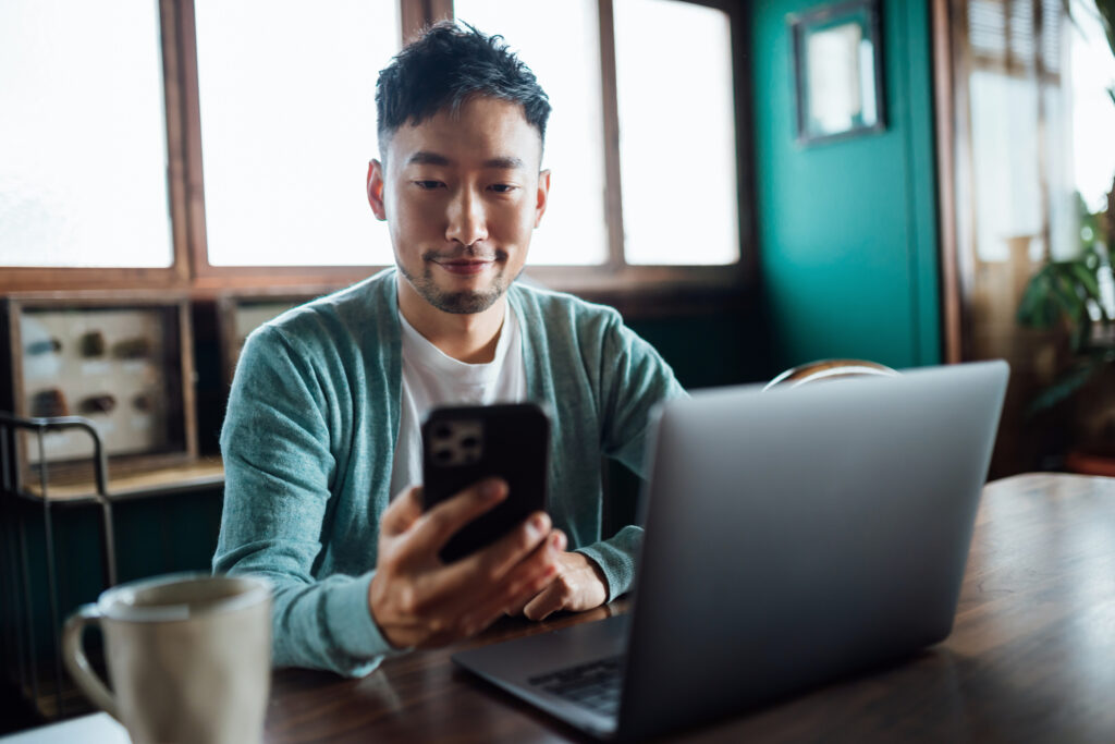 A young man at home on a call with his patient services case manager